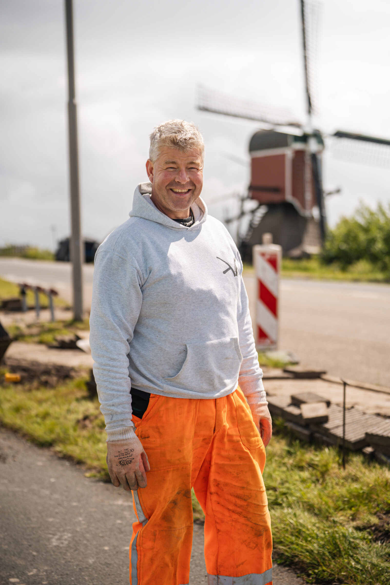Portret van stratenmaker Vincent op de werklocatie tussen het straatwerk.